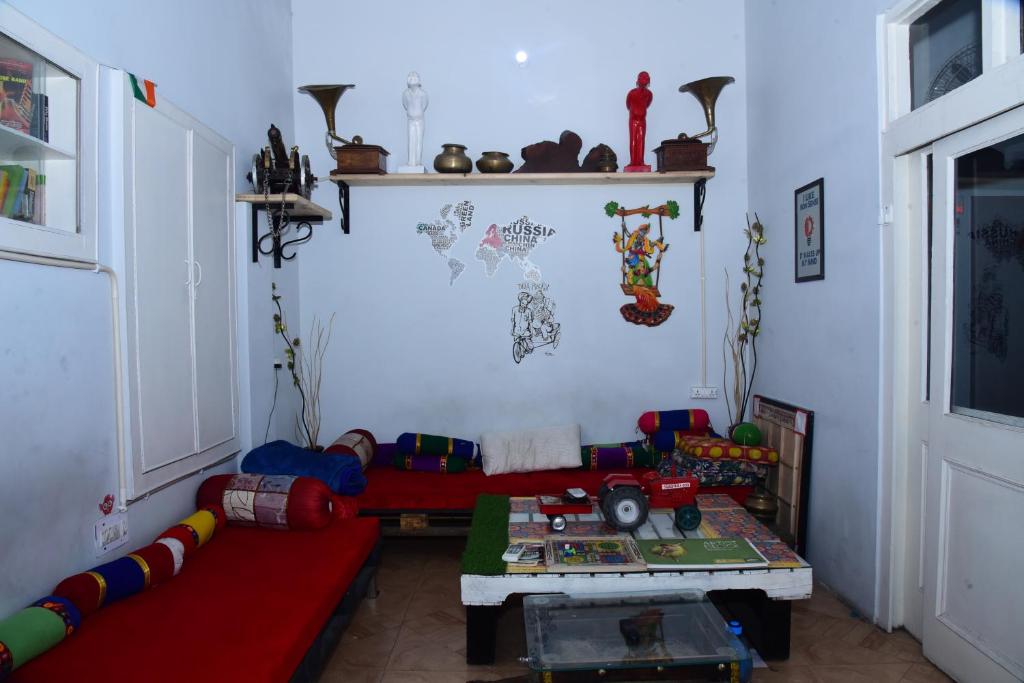 a living room with a couch and a table at Nutz Backpackers in Amritsar