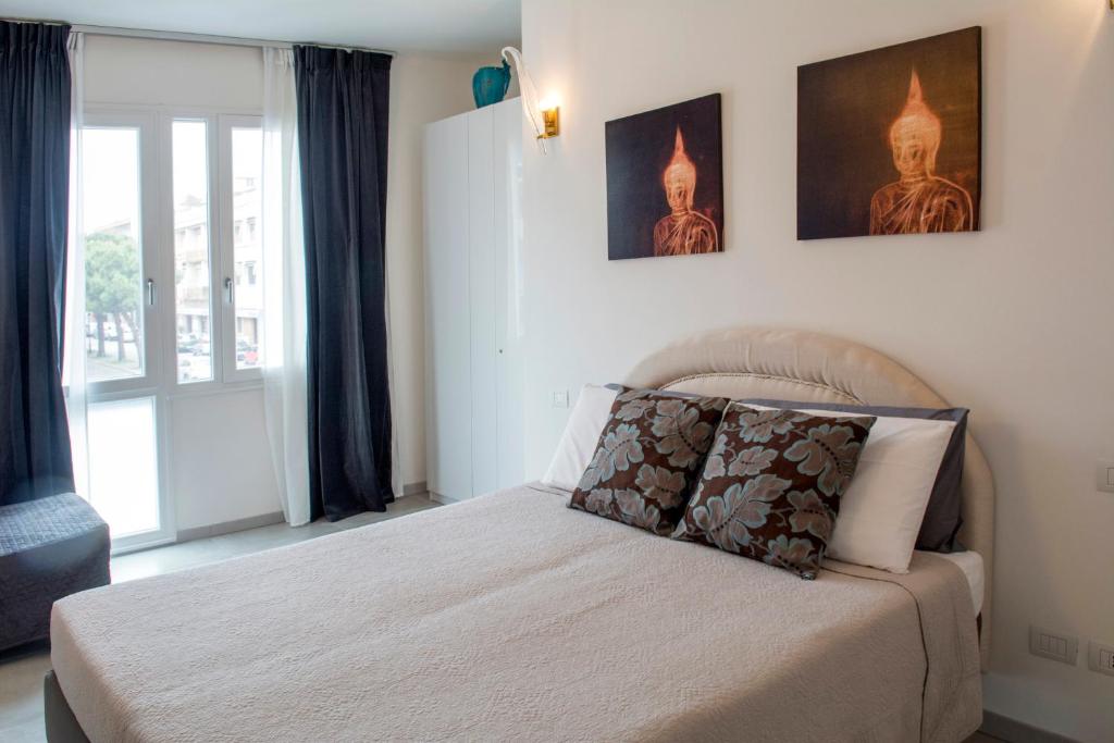 1 dormitorio con 1 cama con 2 cuadros en la pared en Torre San Bonifacio - Locazione Turistica, en San Bonifacio