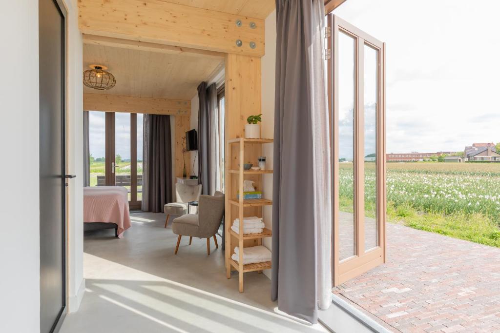 a room with a view of a field of flowers at De Groene Bollenschuur in Hillegom