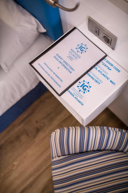 a table with a box on top of a bed at IG Nachosol Atlantic & Yaizasol by Servatur - Adults Only in Puerto Rico de Gran Canaria