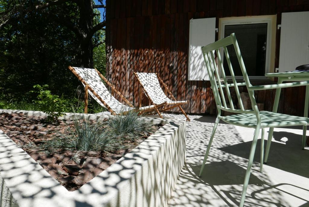 two chairs and a table on a patio at Un chalet au Ventoux - Mont Serein in Mont Serein