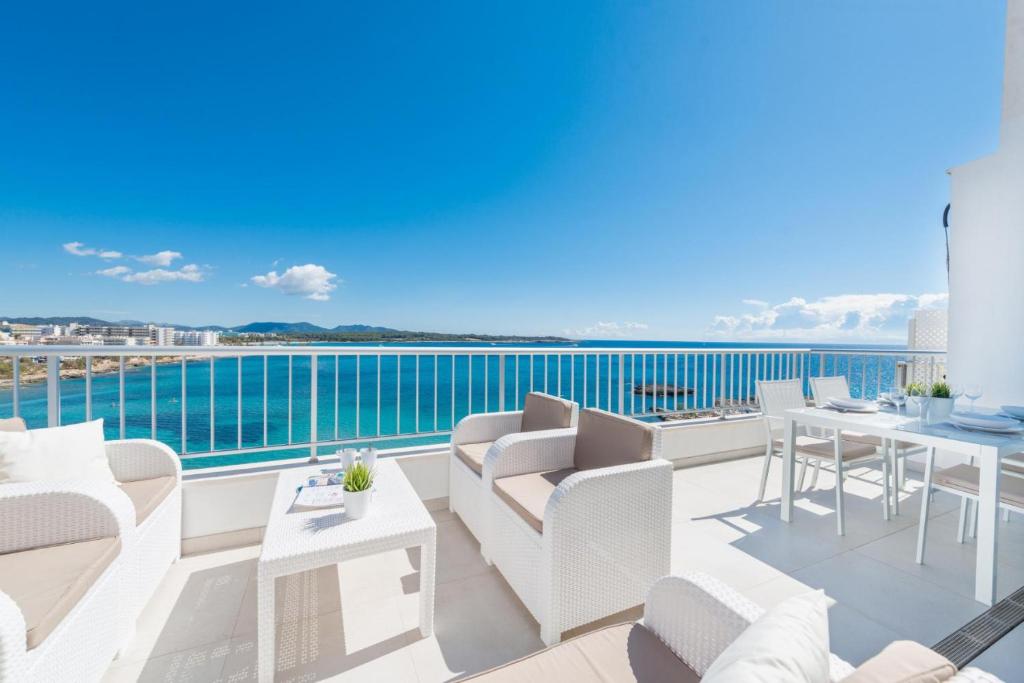 a balcony with white furniture and a view of the water at Luisamar Sea View in Manacor