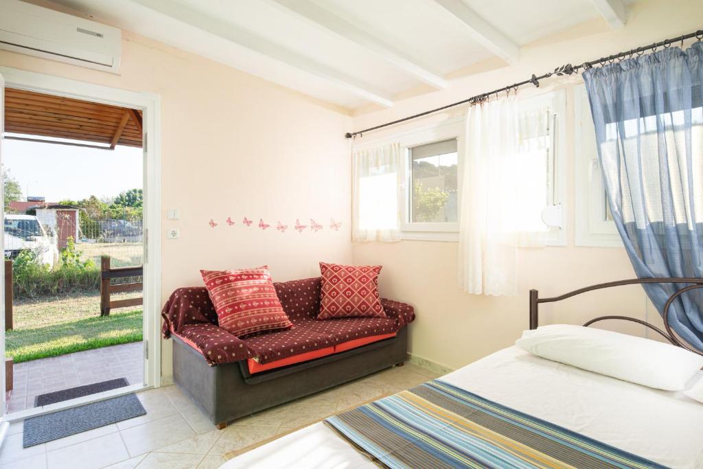a bedroom with a couch and a bed and a window at Agatha house in Valtí