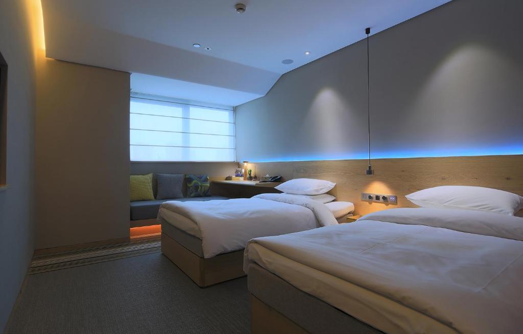 Voodi või voodid majutusasutuse EBO Hotel (Hangzhou West Lake) toas