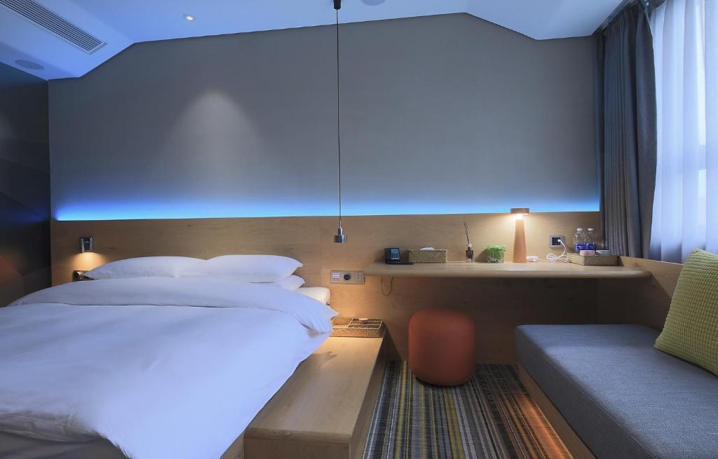 Voodi või voodid majutusasutuse EBO Hotel (Hangzhou West Lake) toas