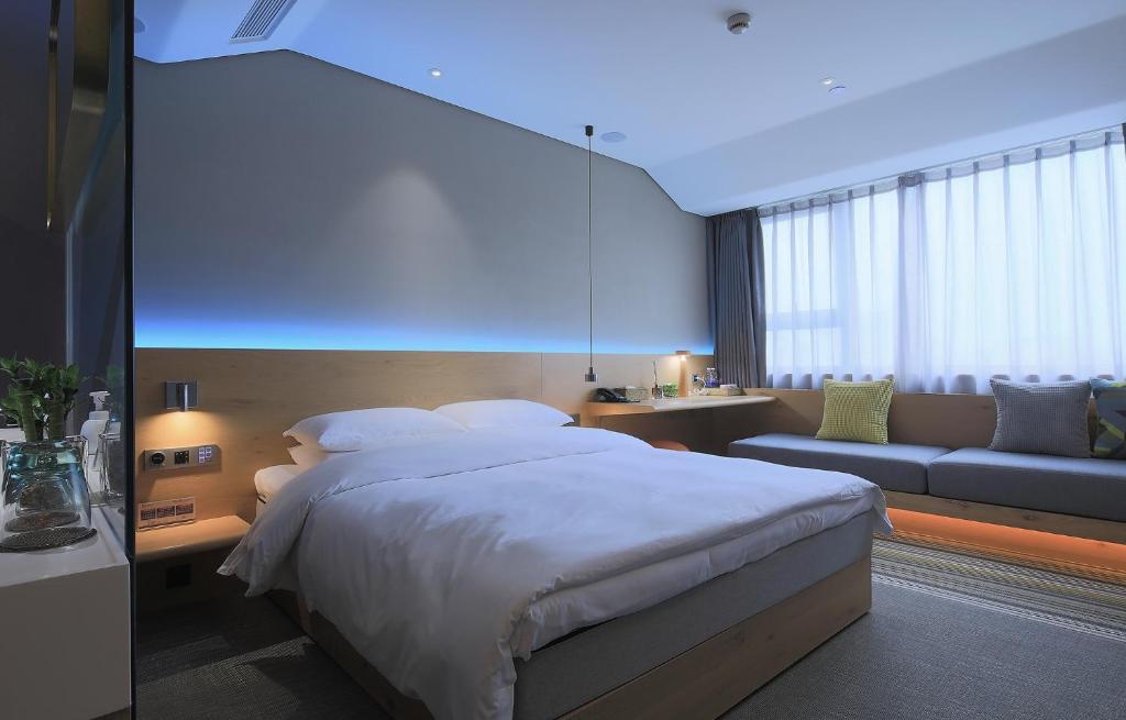 Voodi või voodid majutusasutuse EBO Hotel (Hangzhou West Lake) toas
