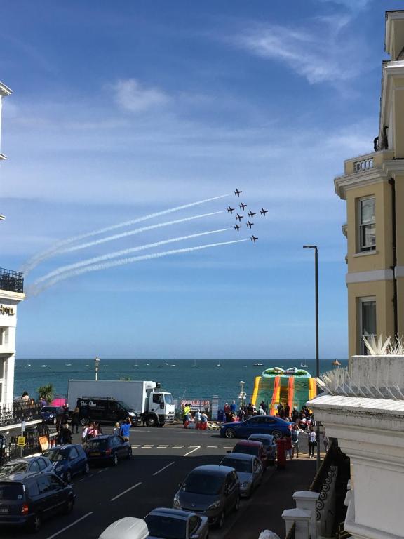 a group of planes flying in formation over a city at Beachview in Eastbourne