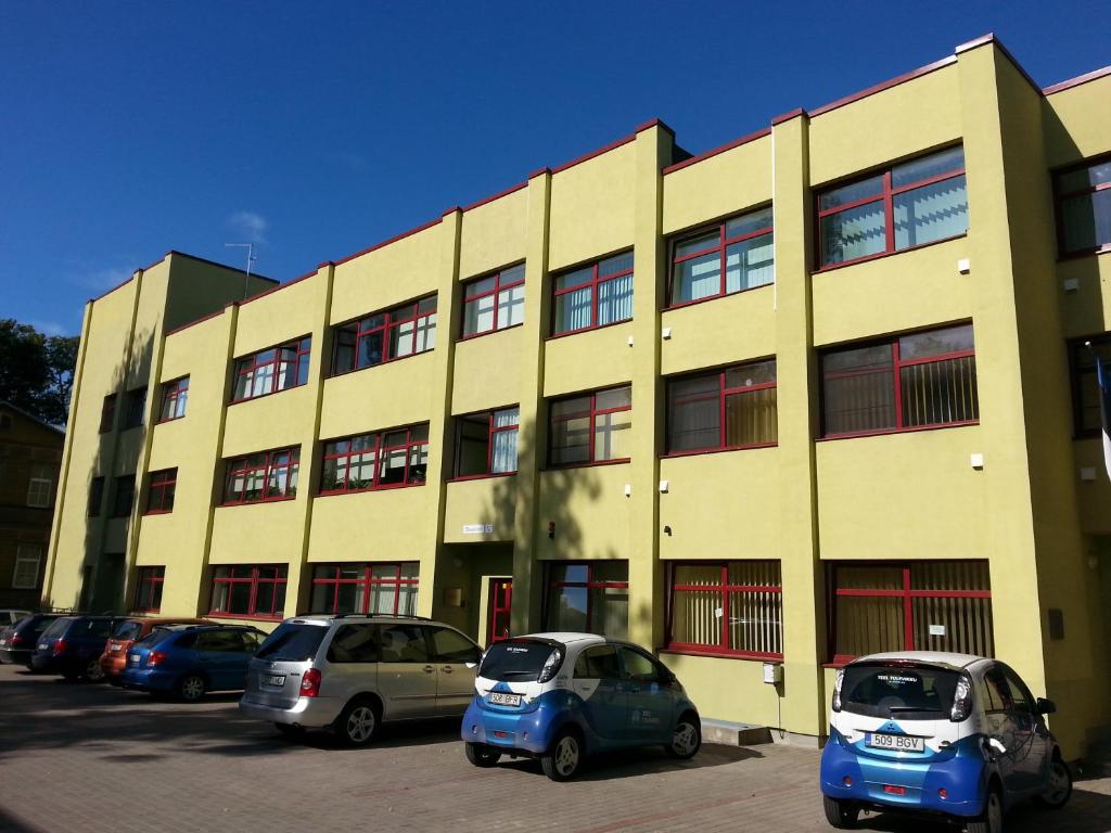 a building with cars parked in front of it at Guesthouse Rehab in Tartu