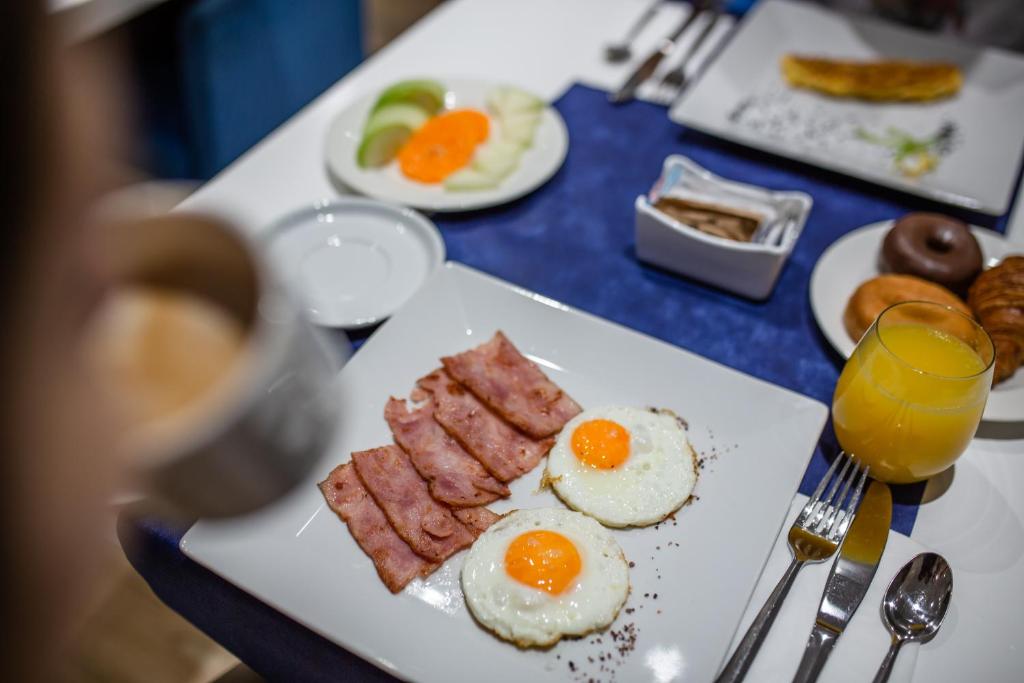 a plate of eggs and bacon on a table at IG Nachosol Atlantic & Yaizasol by Servatur - Adults Only in Puerto Rico de Gran Canaria