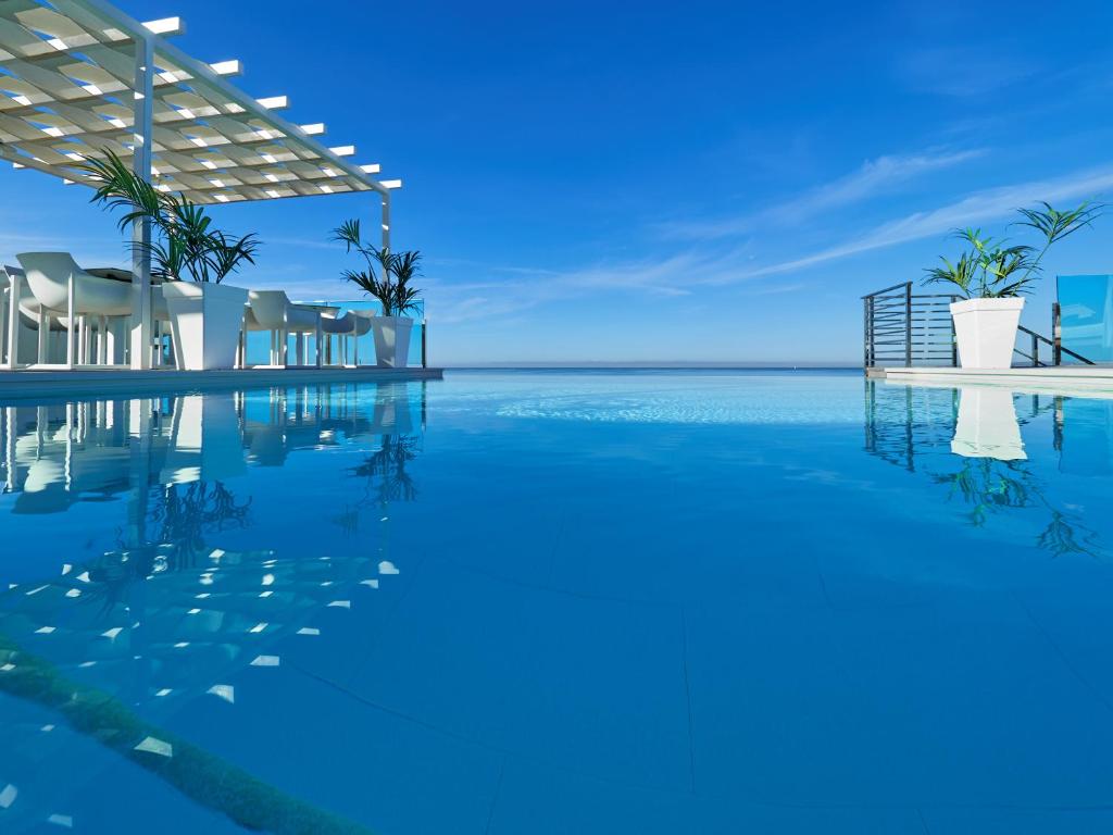 a swimming pool with a view of the ocean at BQ Aguamarina Boutique Hotel in Can Pastilla