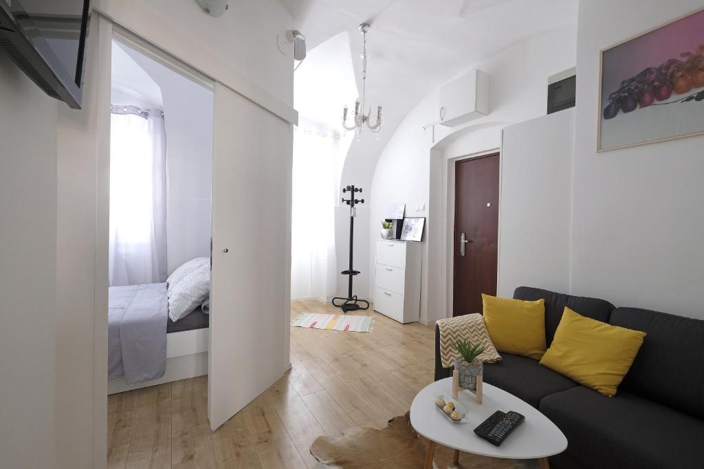 a living room with a couch and a bed at Stone gate in Zagreb