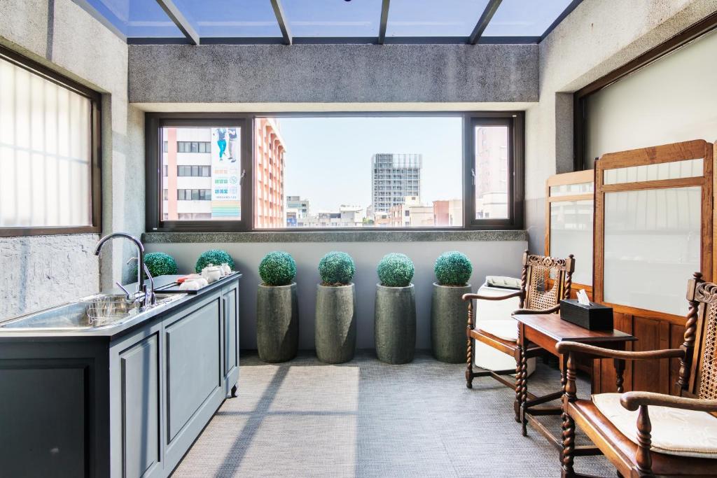 a kitchen with a view of a city from a window at Fun Simon in Tainan