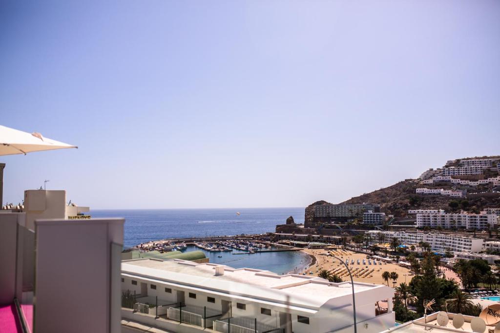 a view of a beach and the ocean from a building at IG Nachosol Atlantic & Yaizasol by Servatur - Adults Only in Puerto Rico de Gran Canaria