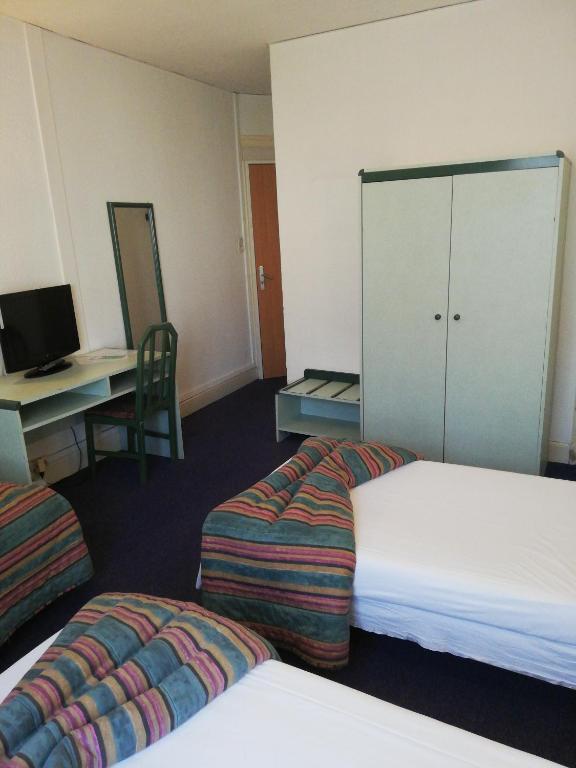 Postel nebo postele na pokoji v ubytování Hôtel de Nevers