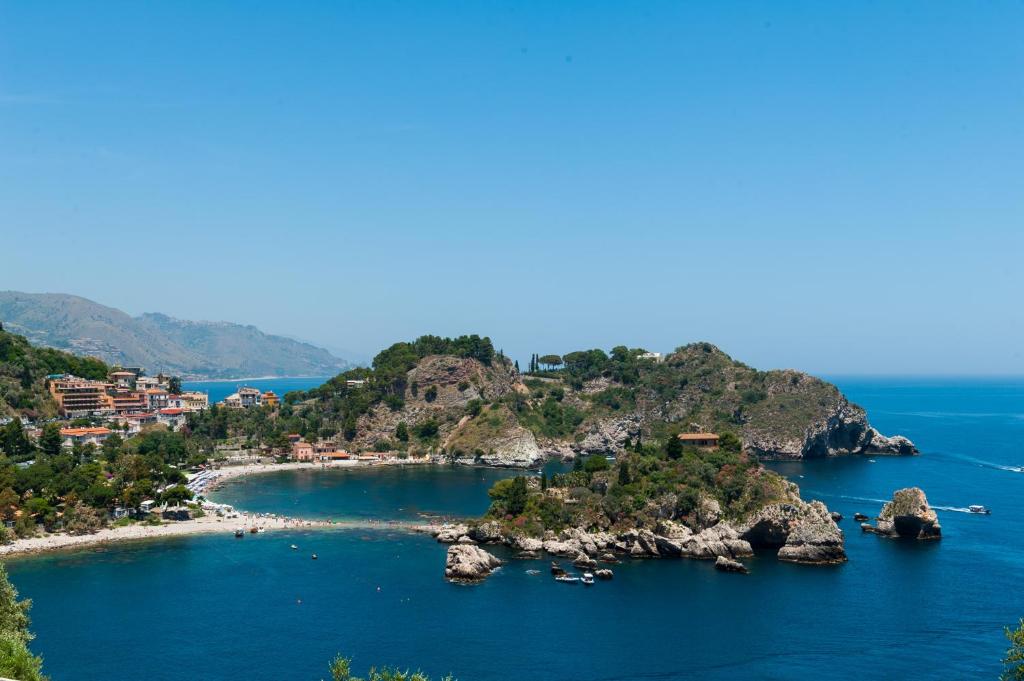 
a large body of water with palm trees at Casa Trevelyan Isola Bella in Taormina
