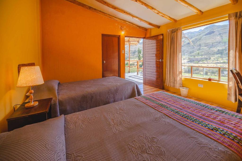 Postel nebo postele na pokoji v ubytování Le Foyer Colca