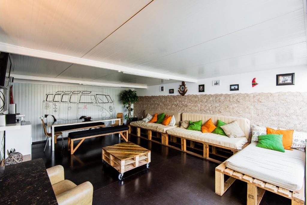 a living room with couches and a table at Hostel & Surfcamp 55 in Ericeira