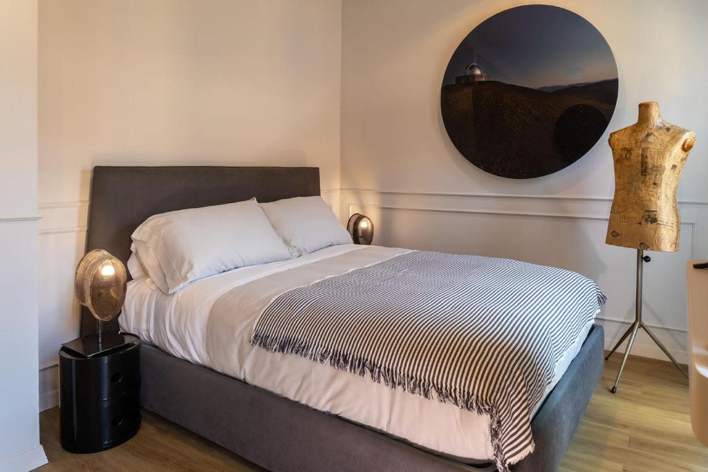a bedroom with a bed and a mirror on the wall at Suites Menaggio in Menaggio