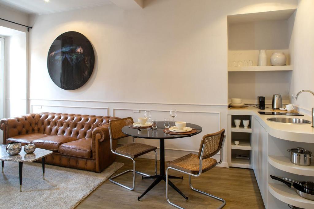 a living room with a couch and a table at Suites Menaggio in Menaggio