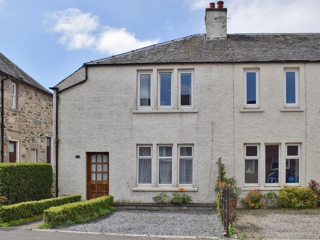 a white brick house with white windows at Brims cottage in Aberfeldy