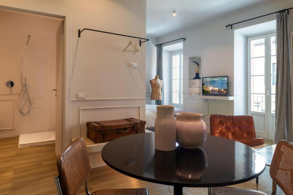 a living room with a table and a fireplace at Suites Menaggio in Menaggio