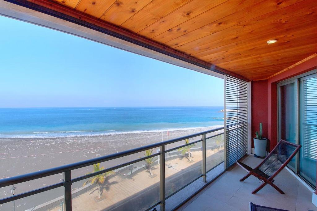 a balcony with a view of the beach at La Sal in Tazacorte