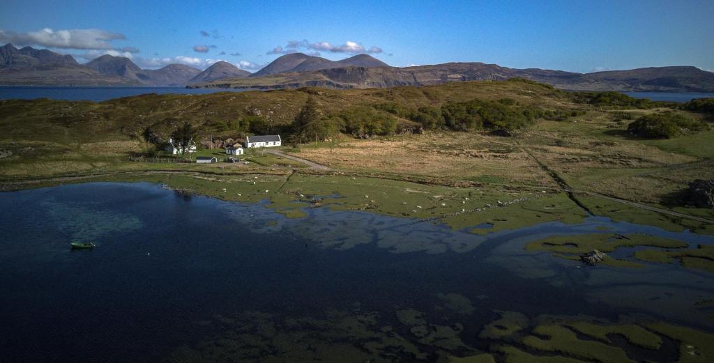 an aerial view of a lake with mountains in the background at Comraich in Tokavaig