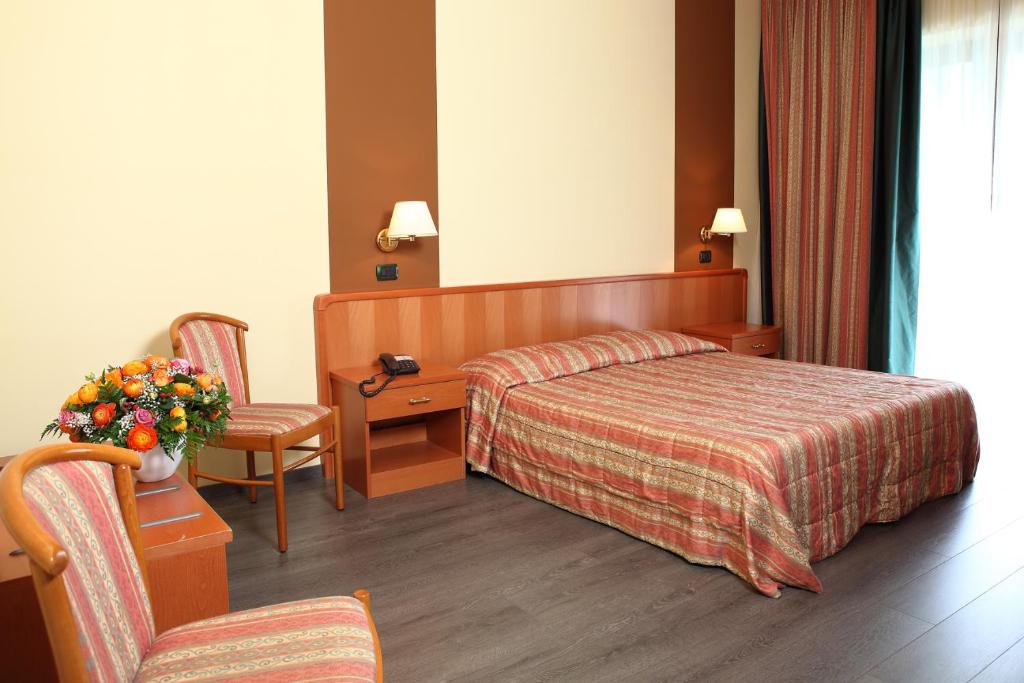 Postel nebo postele na pokoji v ubytování Hotel Romanisio
