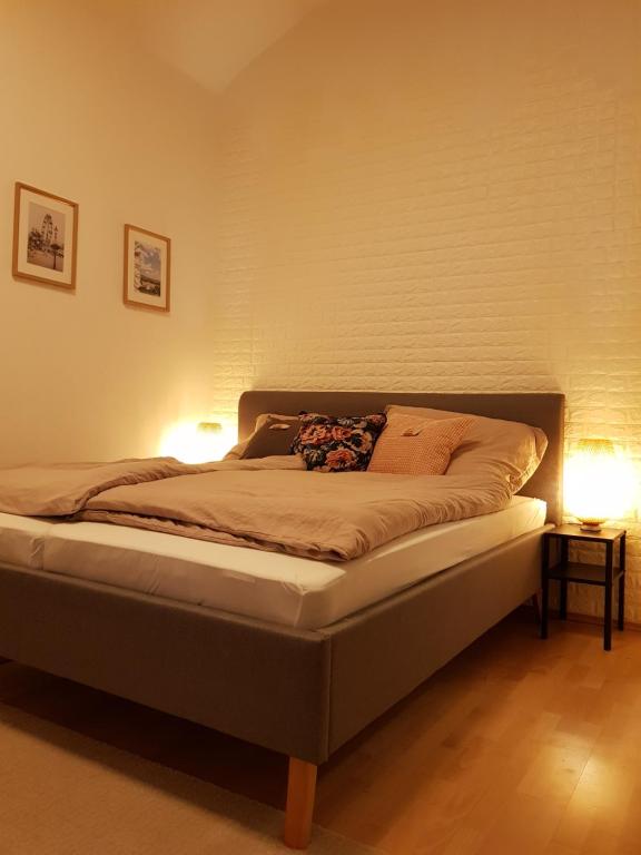 a bedroom with a bed with two lamps on it at Sweet flat in the center of vienna in Vienna