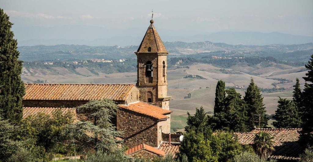 an old church with a steeple on top of a hill at Tuscan retreat in Orciatico