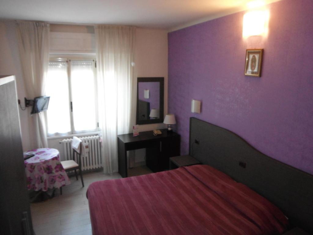 Postel nebo postele na pokoji v ubytování Hotel Renato