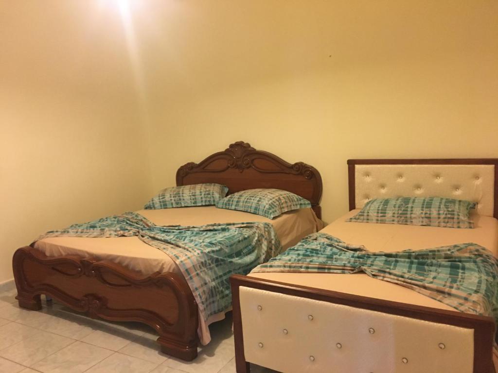 Giường trong phòng chung tại Vila Isufaj