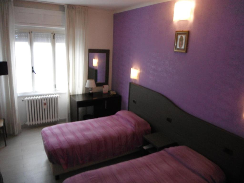 Postel nebo postele na pokoji v ubytování Hotel Renato