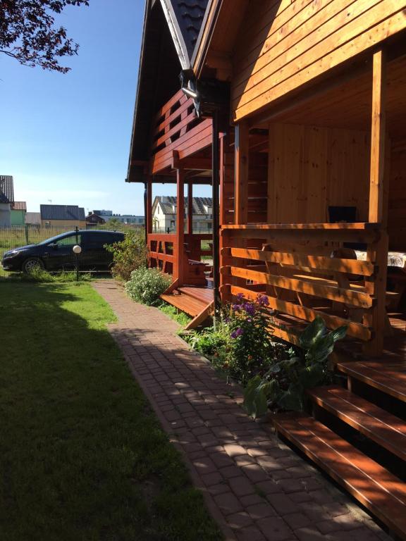 a wooden building with a pathway next to it at Złote Piaski Mielenko in Mielenko