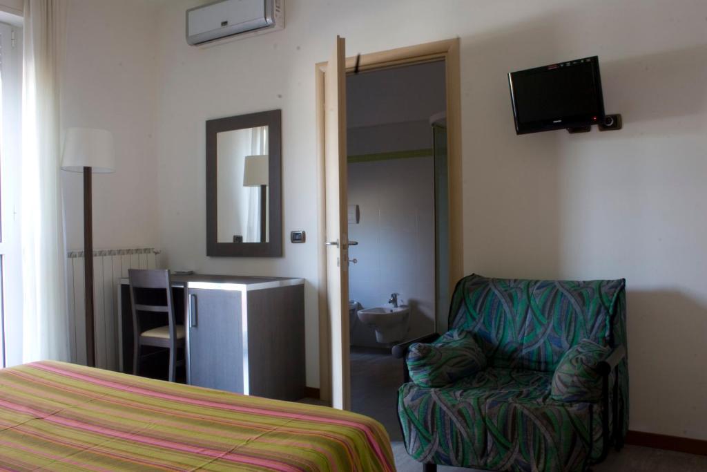 Postel nebo postele na pokoji v ubytování Hotel Renato