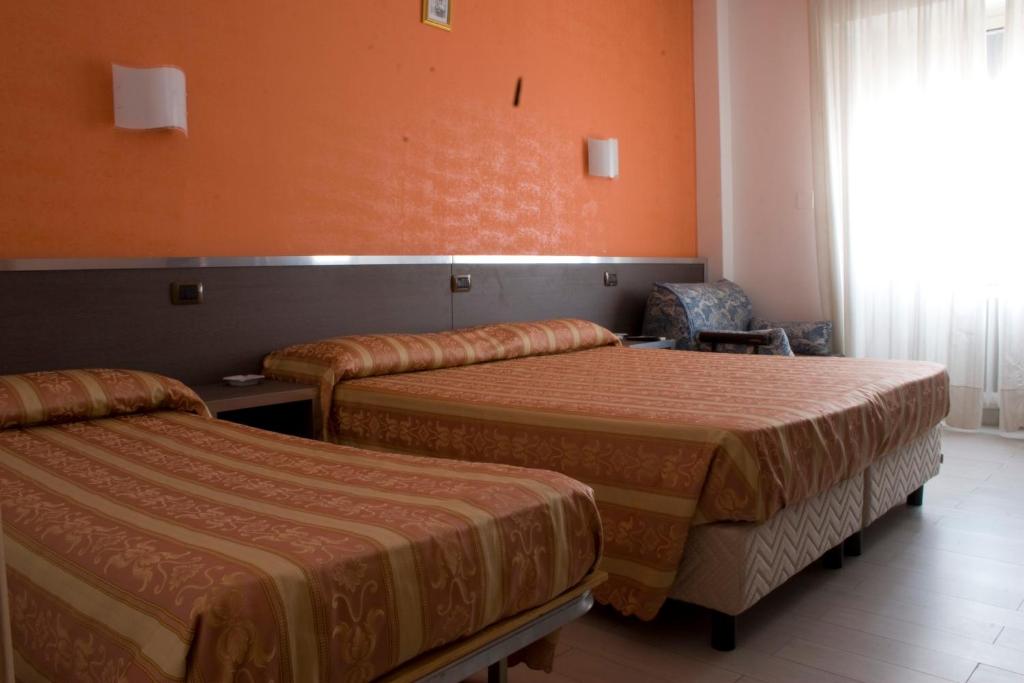 Postel nebo postele na pokoji v ubytování Hotel Renato