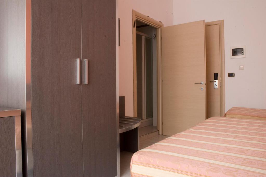 Postel nebo postele na pokoji v ubytování Hotel Renato