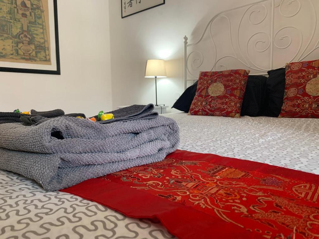 a bed with a blanket and pillows on top of it at Cadorna in Florence