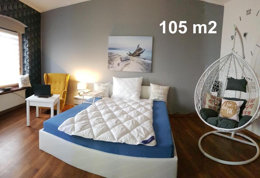 a bedroom with a bed and a swing at Apartament WHITEGRAY Studio 105 m2 in Bytom