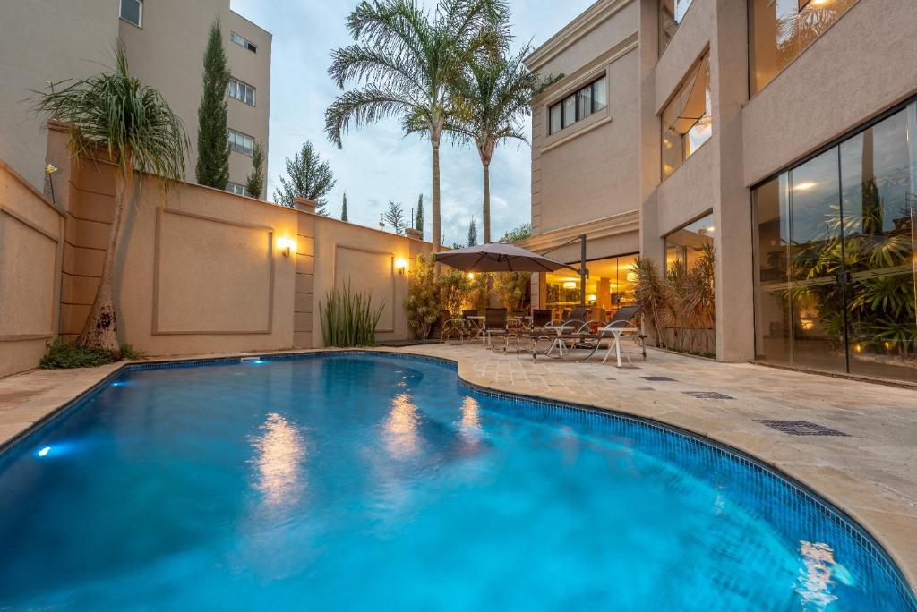 a swimming pool in the backyard of a house at Class Hotel Guaxupé in Guaxupé