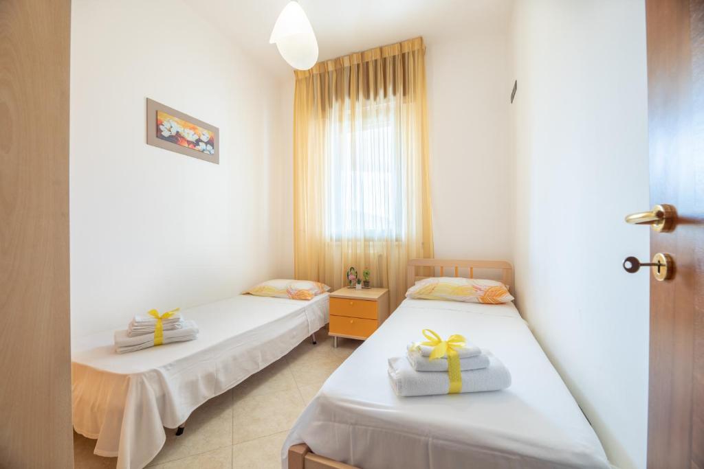 Posteľ alebo postele v izbe v ubytovaní LE NOBILI DIMORE-appartamenti in Residence Rosa Virginia-VISTA MARE