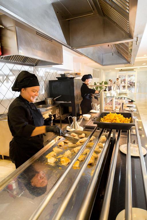 two people in a kitchen preparing food in a kitchen at FERGUS Style Bahamas in Playa d'en Bossa