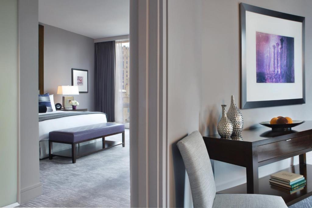 a bedroom with a bed and a desk with a chair at Trump International Hotel & Tower Chicago in Chicago