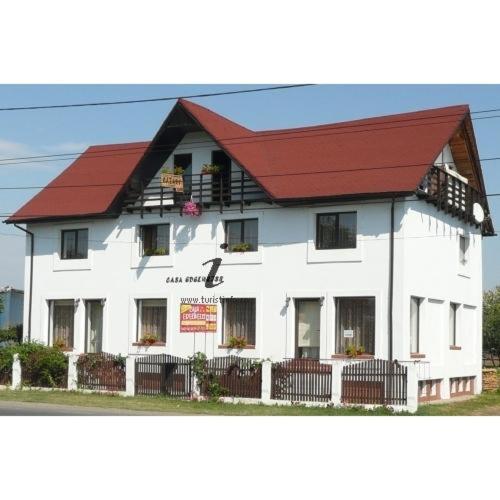 a large white building with a red roof at Camere de inchiriat EDELWEISS in Dumbrava Roşie