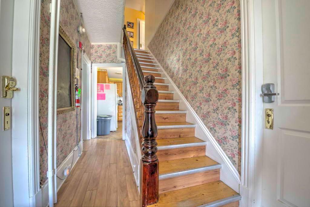 a staircase in a home with wooden floors and a hallway at HI Charlottetown Backpacker's Inn in Charlottetown