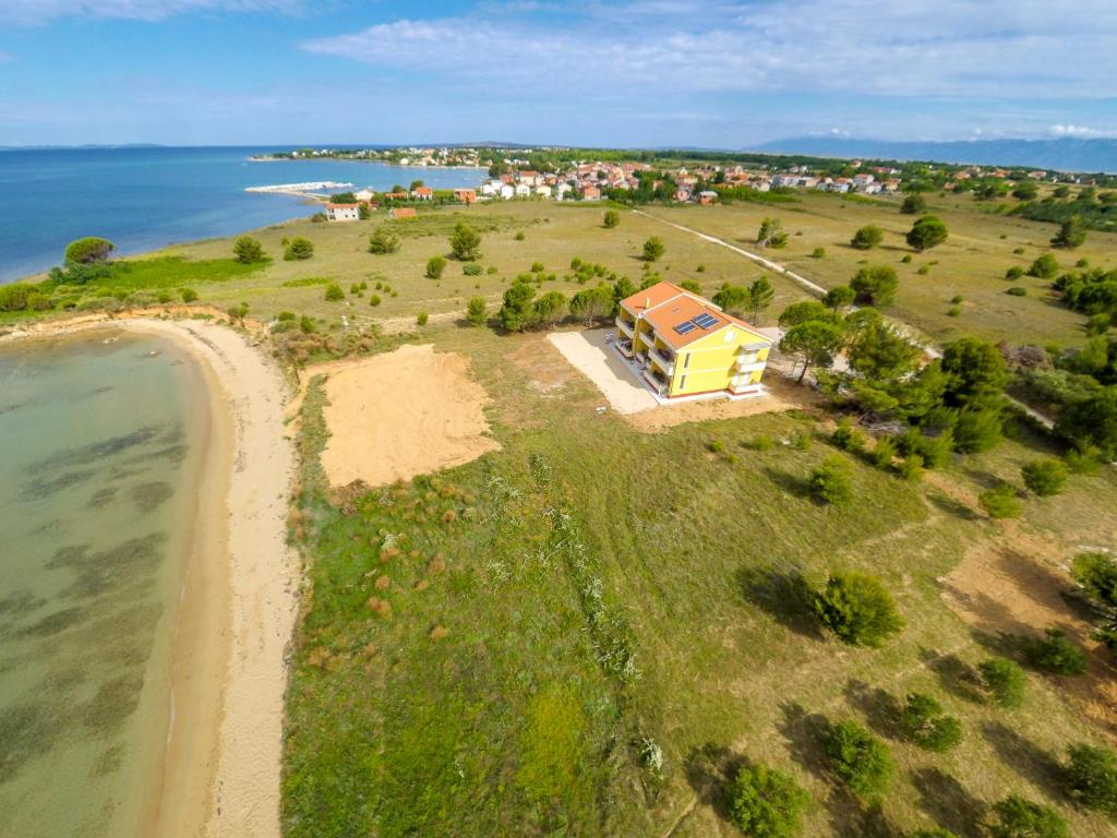 an aerial view of a house on an island near the ocean at Apartments Lily in Nin