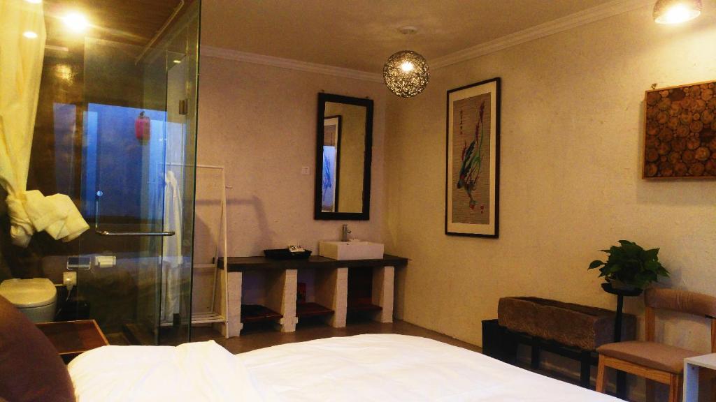 Postel nebo postele na pokoji v ubytování Guixu Huatang Homestay