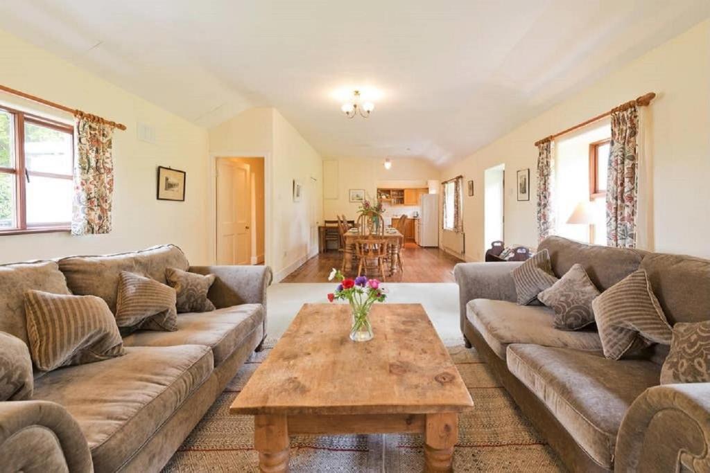 a living room with couches and a coffee table at The Bunker Cottage, Baltray in Drogheda