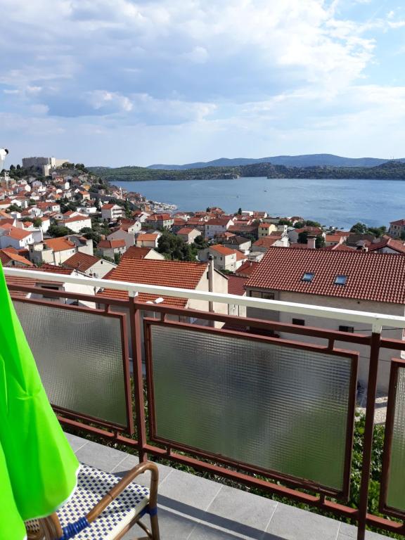 a balcony with a view of a city and water at Apartment Rozalija in Šibenik