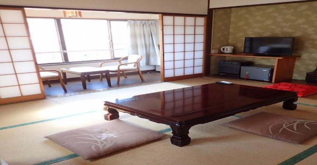 a living room with a coffee table and a television at Oyado Matsubaya / Vacation STAY 8062 in Obinata